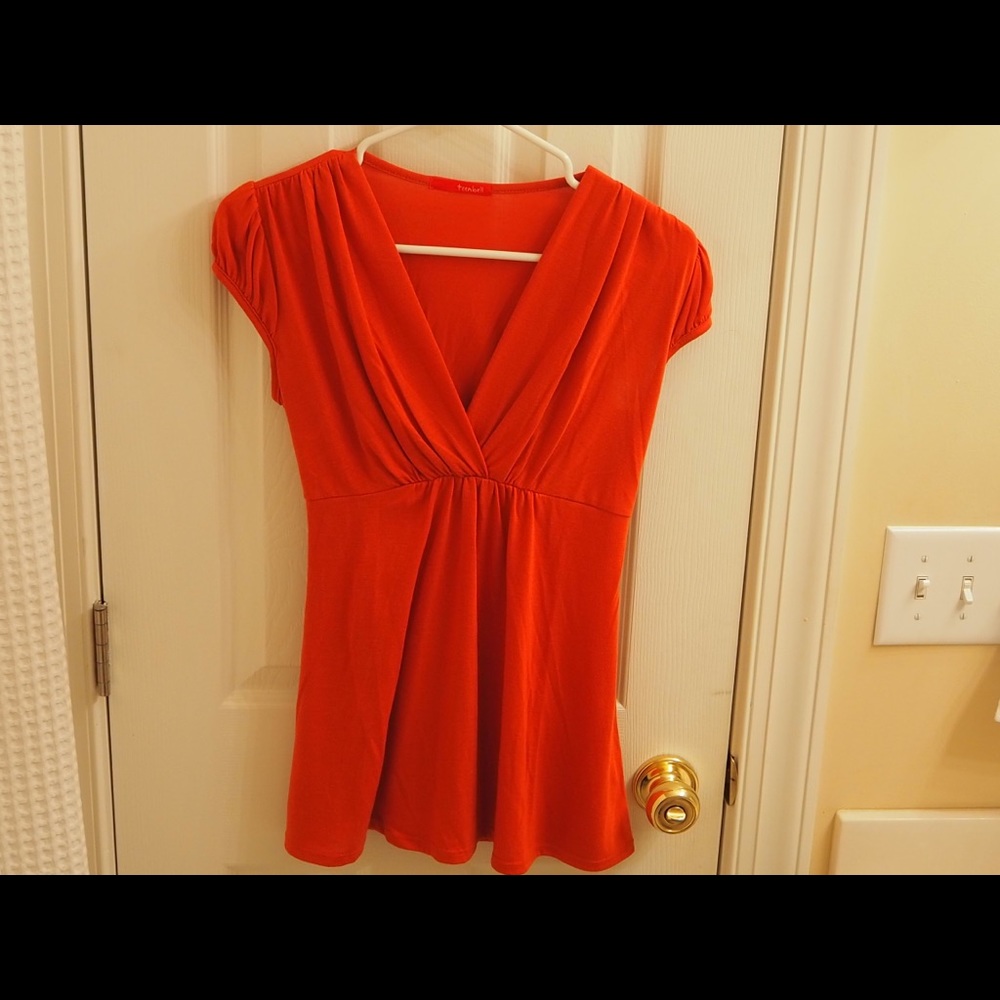Short and cap-sleeved orange/red top with flared and flowey waist.